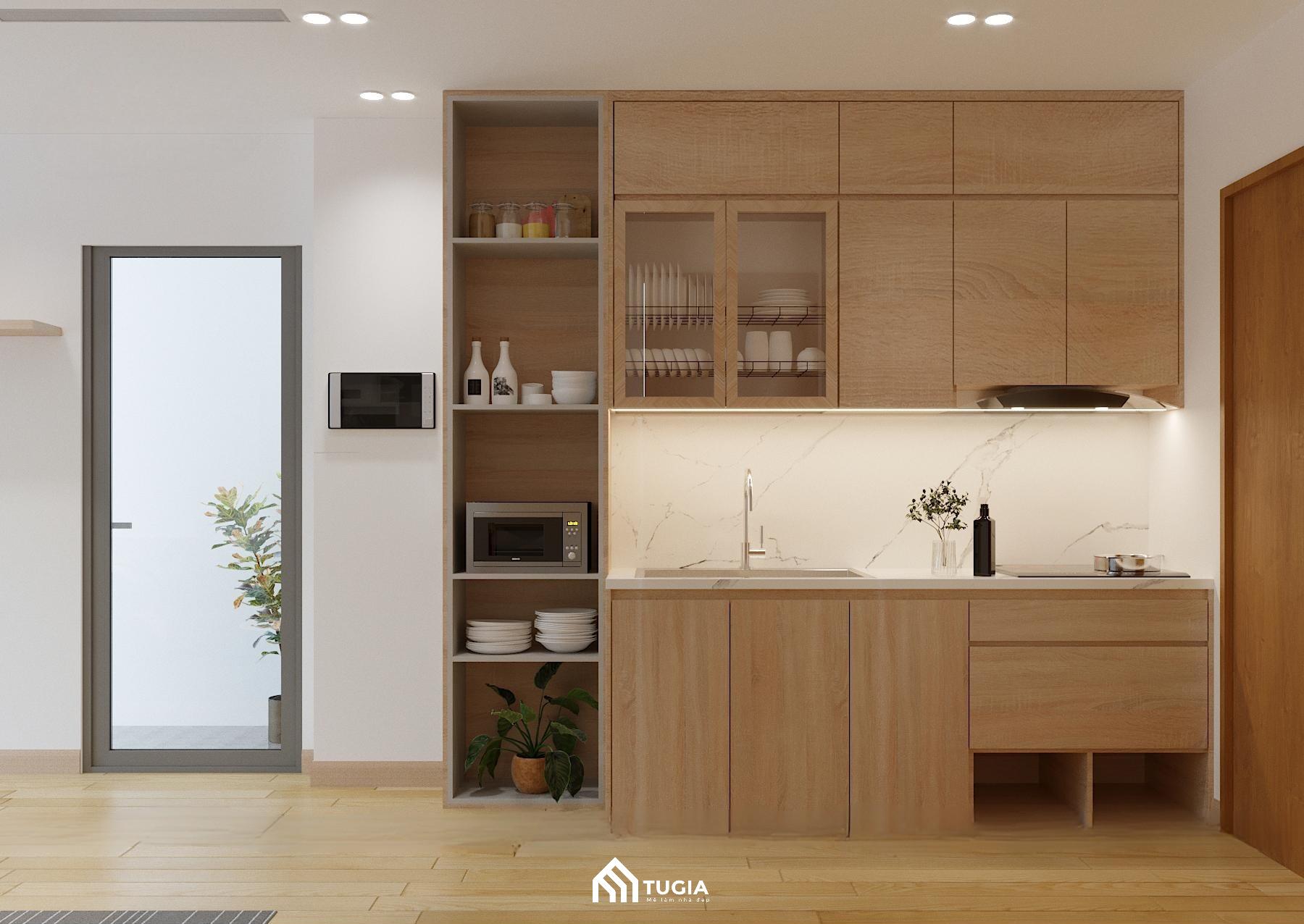 Khu vực nấu nướng nhỏ gọn và đầy đủ tiện nghi với hệ tủ bếp bằng gỗ công nghiệp