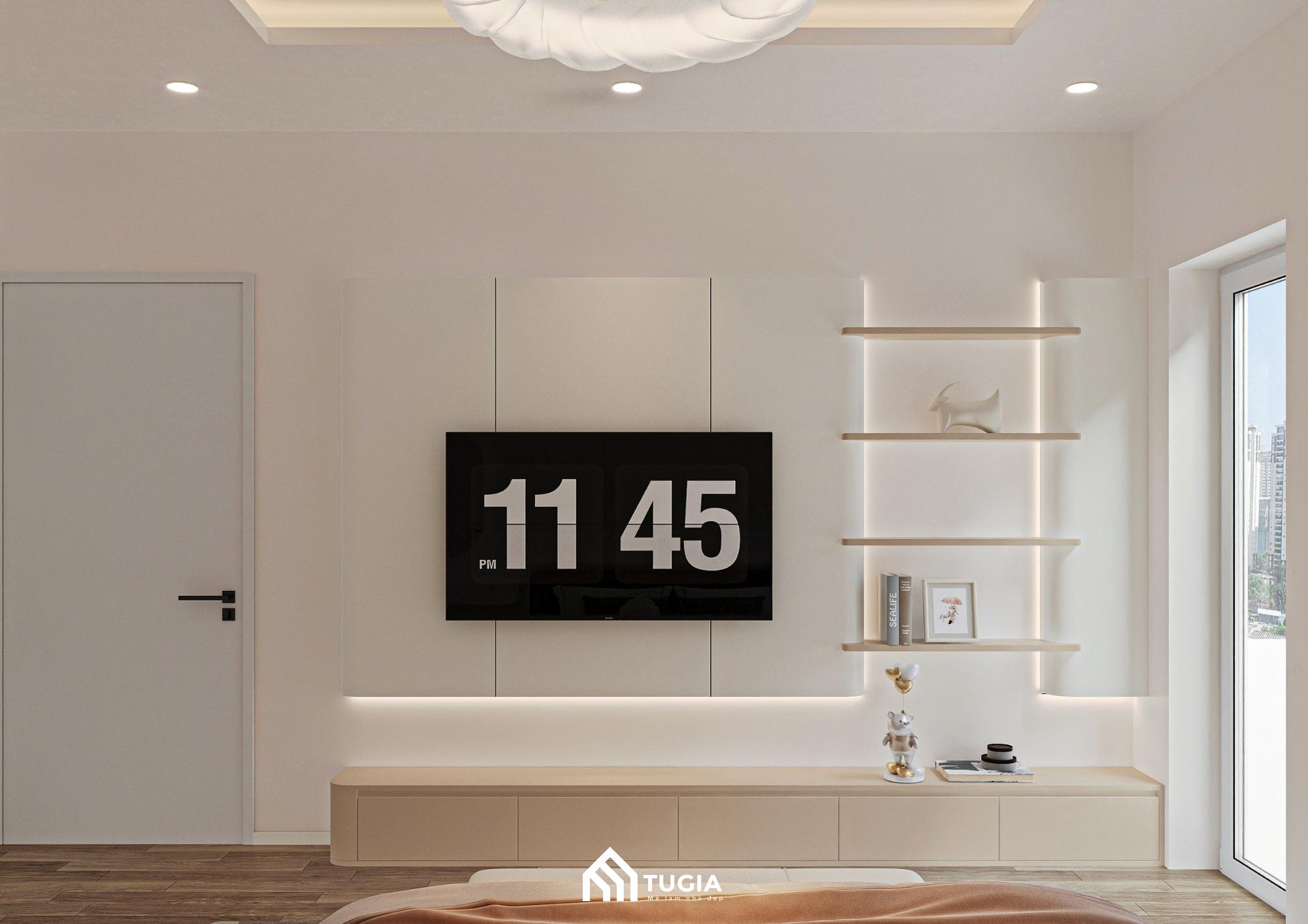 Vách tivi được thiết kế hiện đại với tông màu sáng, đi cùng kệ treo tường dùng để trưng bày sách, tượng nhỏ hoặc đồ lưu niệm