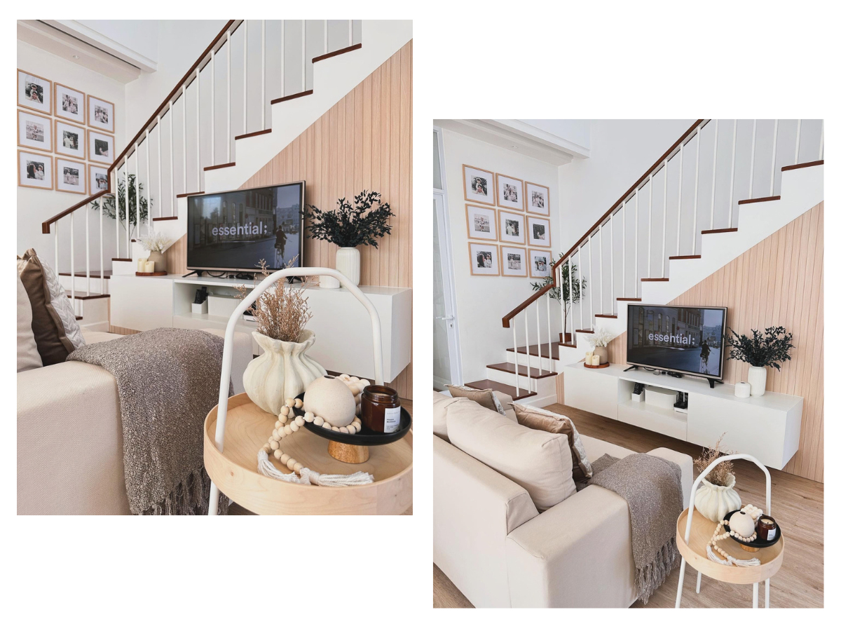 Thiết kế nội thất phòng khách nhà ống hiện đại với kệ tivi màu trắng được bố trí thông minh dưới gầm cầu thang.