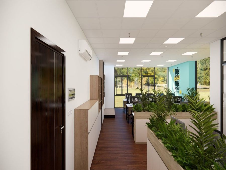 Thiết kế văn phòng làm việc hiện đại với một vài chậu cây xanh được đặt trên kệ níu kéo lại không gian thoáng rộng